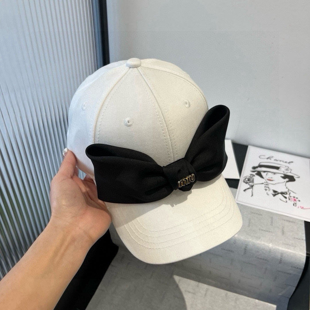MIU MIU MM BASEBALL CAP IN WHITE FABRIC WITH LARGE BLACK BOW