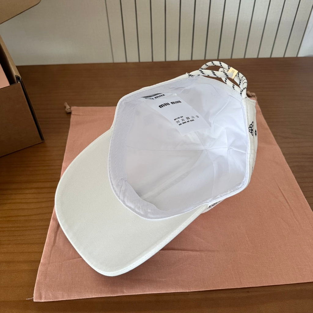 MIU MIU MM BASEBALL CAP IN WHITE WITH BLACK EMBROIDERED PATTERN