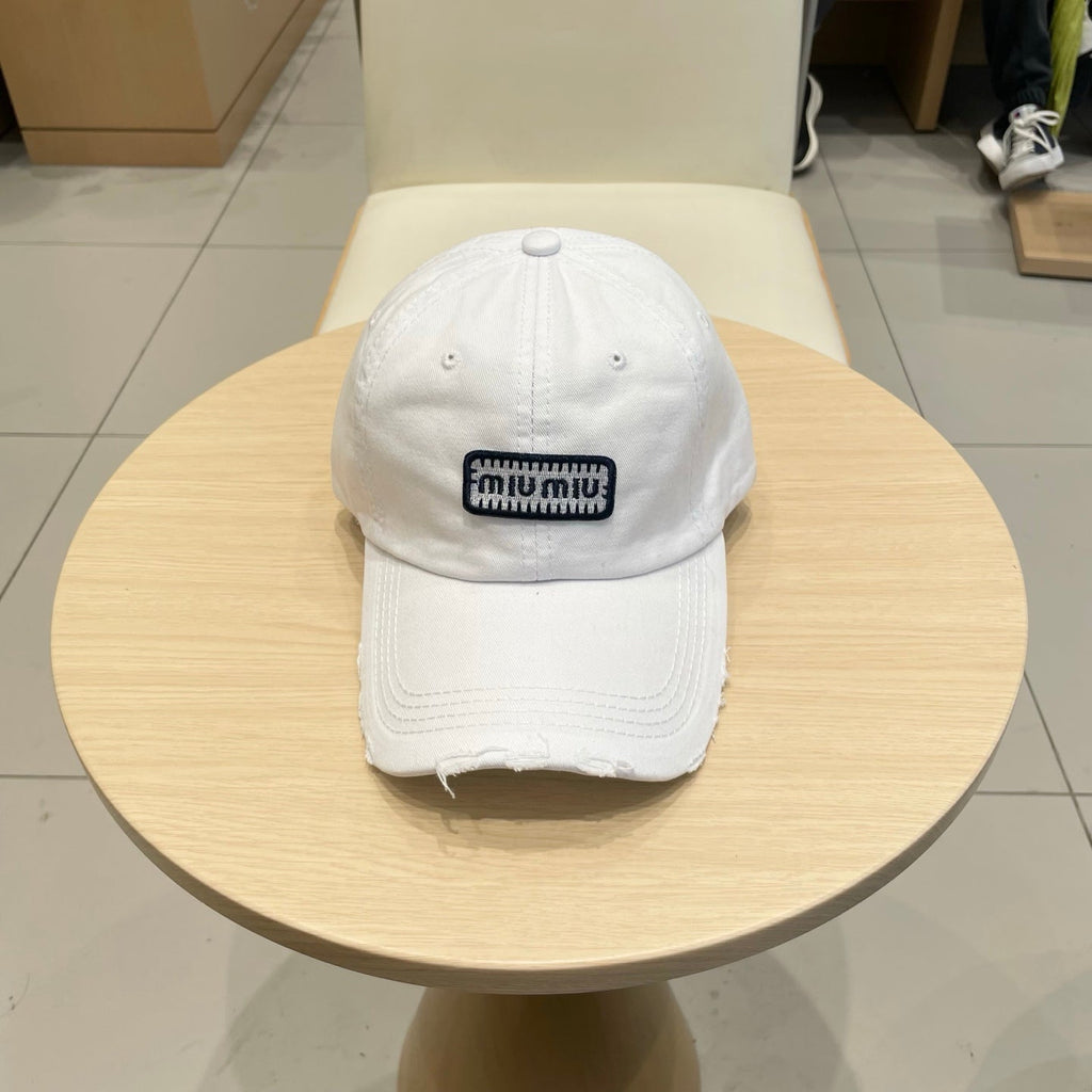 MIU MIU MM DISTRESSED FABRIC BASEBALL CAP IN WHITE WITH EMBROIDERED LOGO