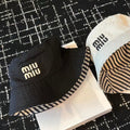 MIU MIU MM CLASSIC REVERSIBLE BUCKET HAT IN LIGHT BEIGE AND BLACK FABRIC