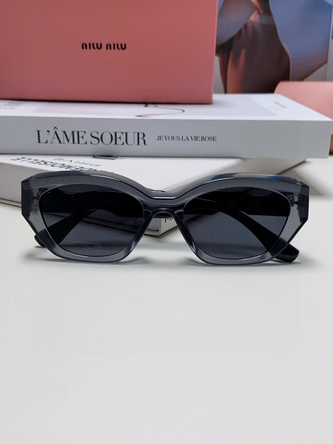 MIU MIU LOGO CAT EYE SUNGLASSES 513006 IN BLACK AND GREY CLEAR ACETATE WAVY FRAME