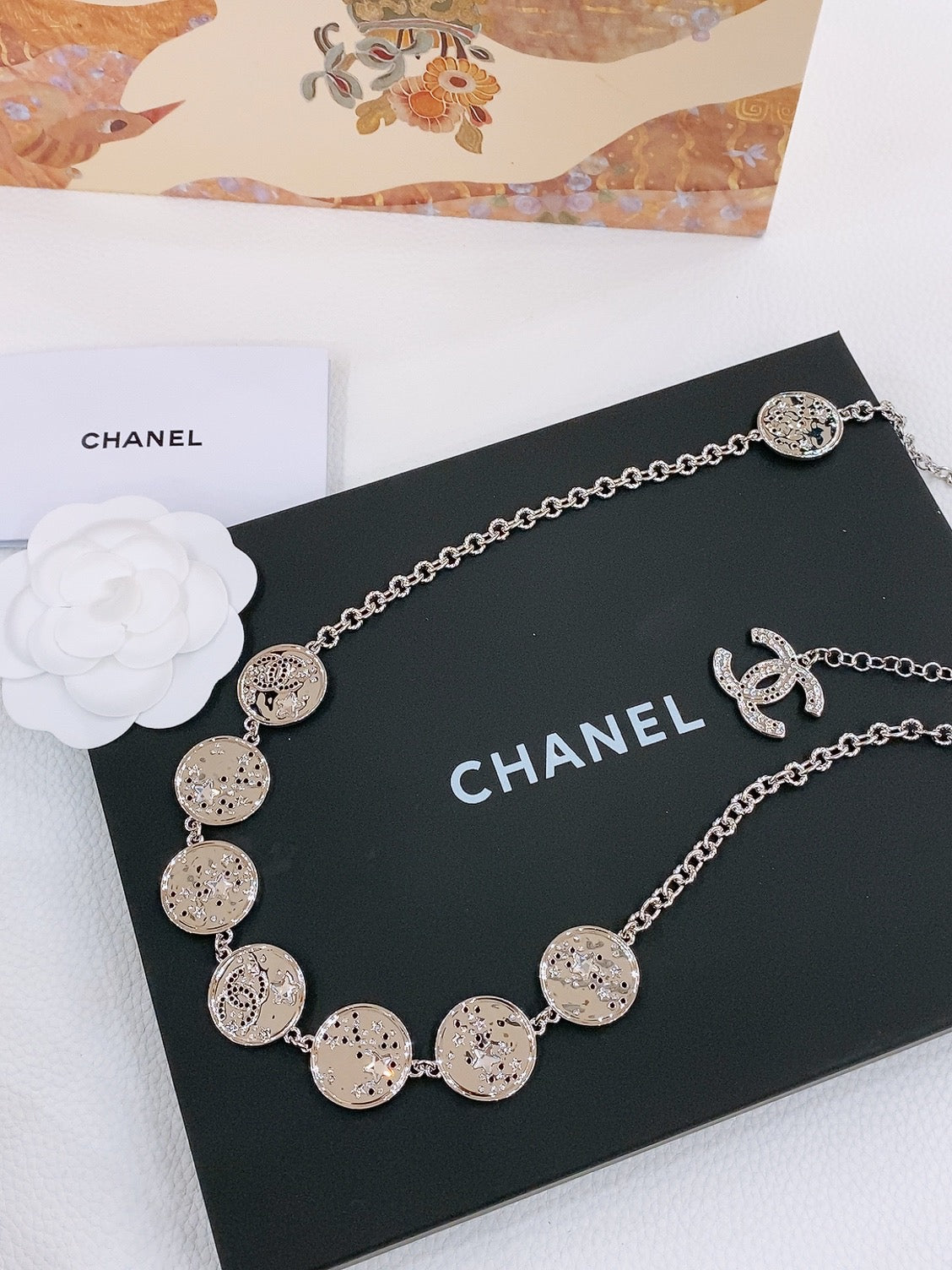CHANEL TWISTED CHAIN BELT WITH RHINESTONES AND LOGO PLATE IN SILVER TONE