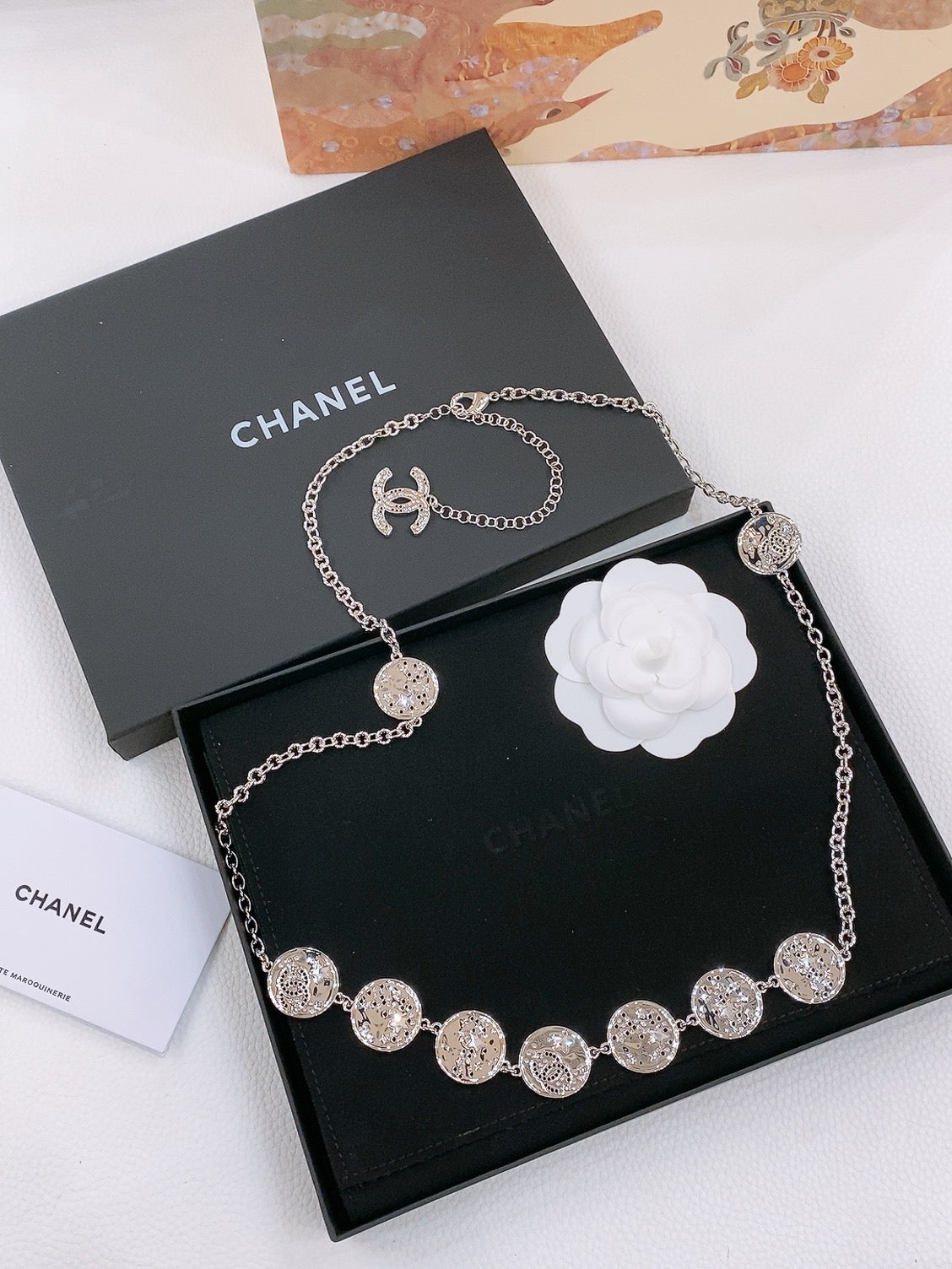 CHANEL TWISTED CHAIN BELT WITH RHINESTONES AND LOGO PLATE IN SILVER TONE