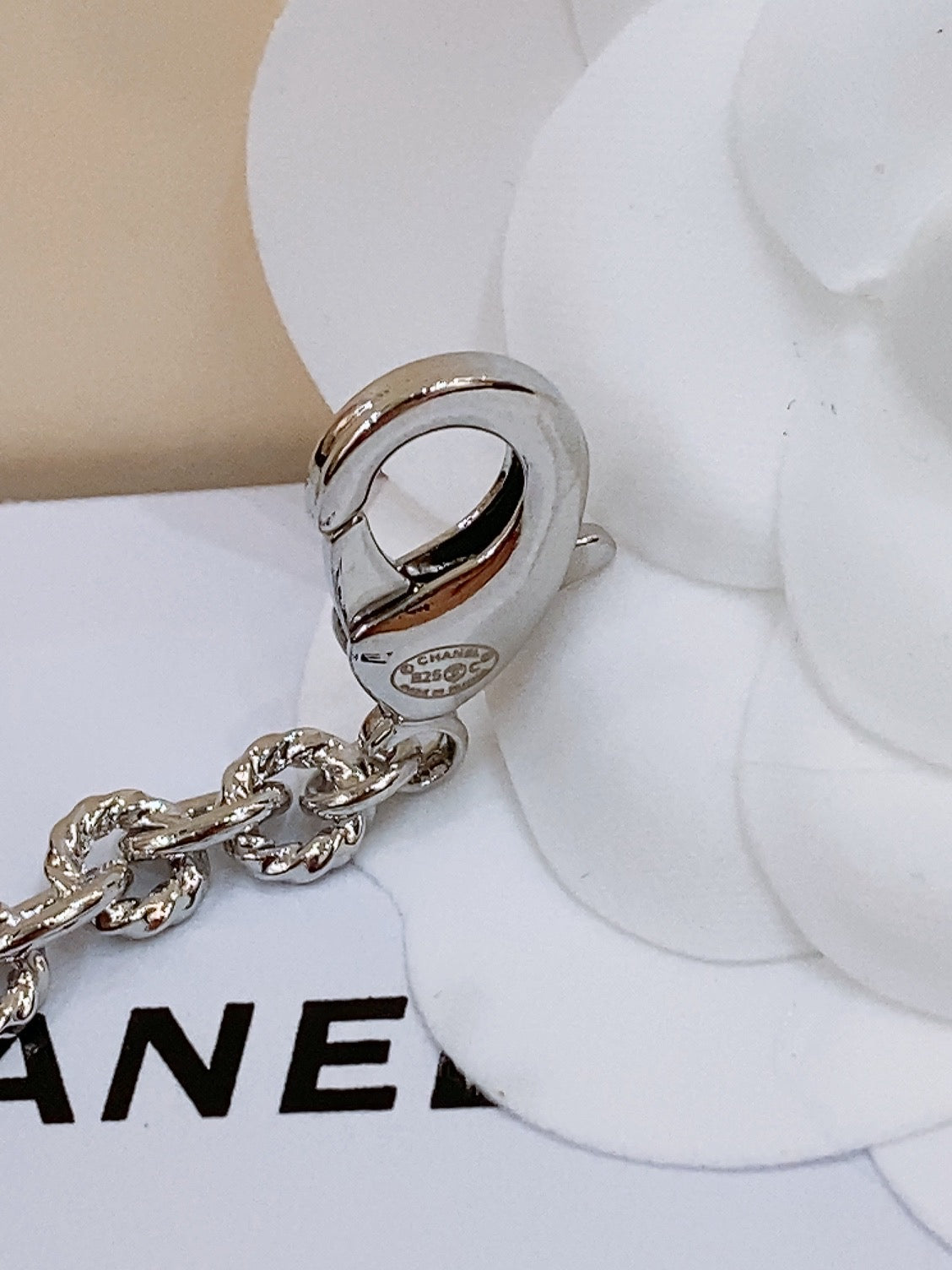 CHANEL TWISTED CHAIN BELT WITH RHINESTONES AND LOGO PLATE IN SILVER TONE